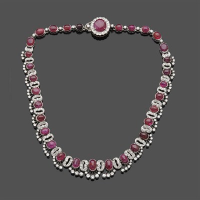 Lot 539 - A Ruby and Diamond Necklace, graduated oval cabochon rubies are alternated with diamond set...