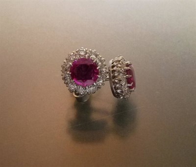 Lot 552 - A Pair of Ruby and Diamond Cluster Stud Earrings, the round brilliant cut rubies in white claw...