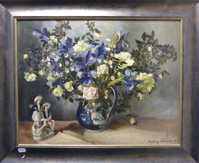 Lot 2202 - Audrey Johnson (1919-2005) Still life of flowers in a Delft jug with a figurine Signed and...