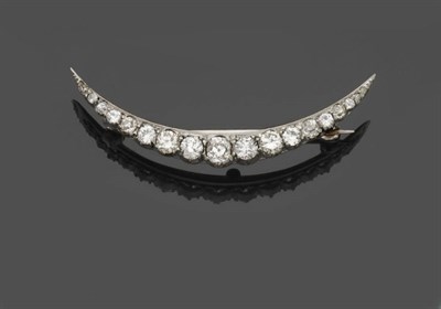 Lot 571 - A Diamond Crescent Brooch, set with graduated old brilliant cut diamonds in white claw...