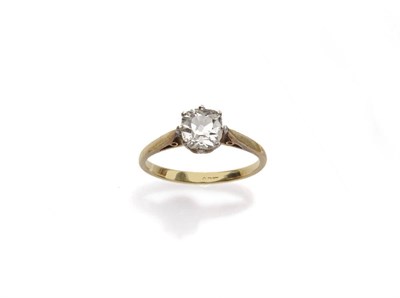 Lot 575 - A Diamond Solitaire Ring, the cushion cut diamond in a white claw setting on a yellow tapered...