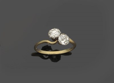 Lot 579 - A Diamond Two Stone Twist Ring, the old brilliant cut diamonds in white claw settings on a...