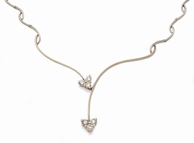 Lot 585 - An 18 Carat Gold Diamond Set Necklace, a graduated wavy link design terminates in a crossover...