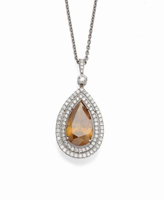 Lot 587 - A Diamond Cluster Pendant on Chain, the pear cut brown diamond within a double border of small...