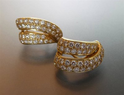 Lot 603 - A Pair of 18 Carat Gold Diamond Cuff Earrings, each swirling double bar bears pavé set round...