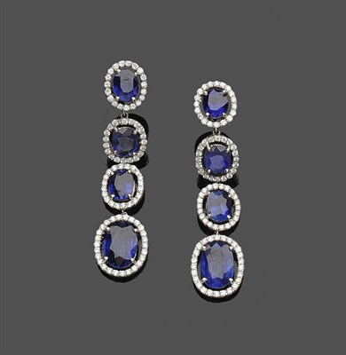 Lot 605 - A Pair of Sapphire and Diamond Drop Earrings, a line of four graduated oval mixed cut sapphires are