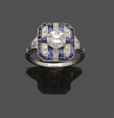 Lot 612 - A Diamond and Sapphire Ring, a round brilliant cut diamond set within a geometric frame of...