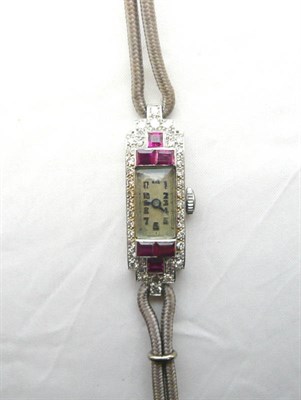 Lot 618 - An Art Deco Lady's Platinum Diamond and Ruby Set Wristwatch, the oblong dial with Arabic...