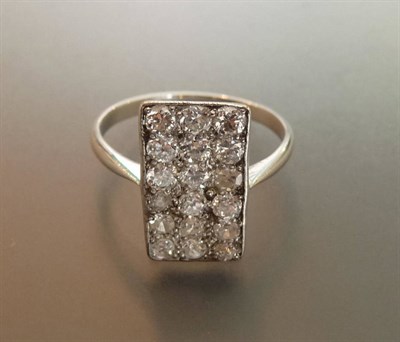 Lot 620 - An Oblong Diamond Cluster Ring, round brilliant cut diamonds in a white pavé setting on a...