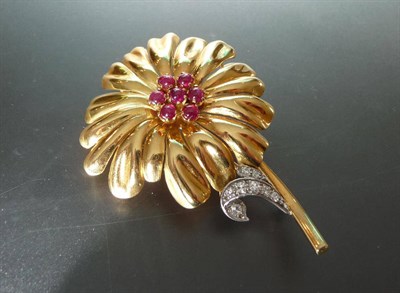 Lot 621 - A Ruby and Diamond Flower Brooch, the stylised motif of yellow shaped petals, a cluster of cabochon