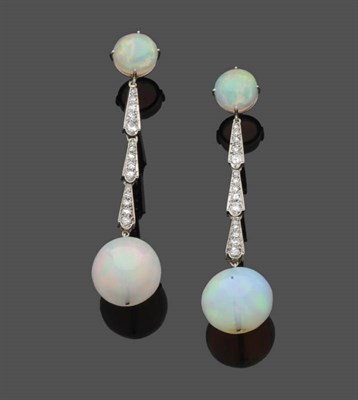 Lot 633 - A Pair of Opal and Diamond Drop Earrings, a round cabochon opal suspends three tapered diamond...