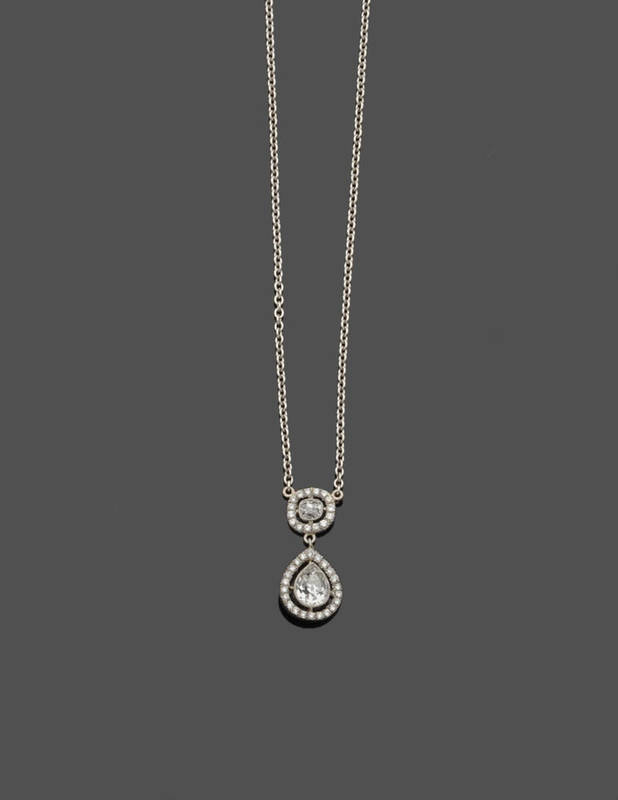 Lot 635 - A Diamond Pendant on Chain, a cushion cut diamond within a diamond set frame suspends a pear...
