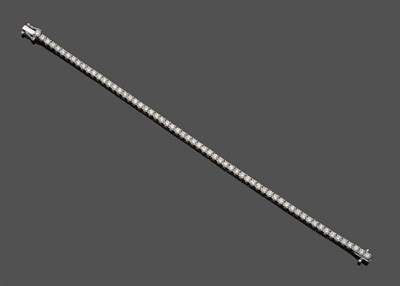 Lot 638 - An 18 Carat White Gold Diamond Line Bracelet, the round brilliant cut diamonds held in four...