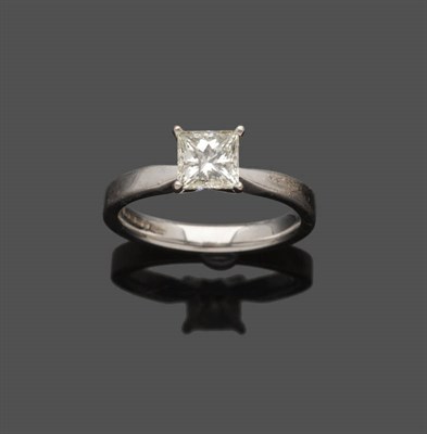 Lot 642 - An 18 Carat White Gold Princess Cut Diamond Solitaire Ring, in a four claw setting, to a plain...