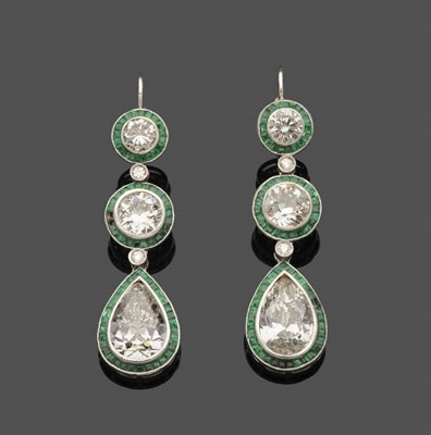 Lot 646 - A Pair of Diamond and Emerald Drop Earrings, two graduated clusters of round brilliant cut...