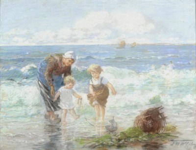 Lot 681 - Jessie M. McGeehan (1872-c.1962) Mother and her Children Playing with a Toy Boat on a Beach Signed