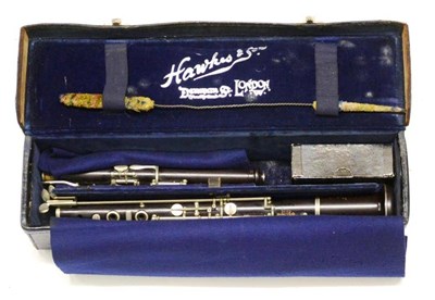 Lot 2067 - A Hawkes & Son Wooden Oboe, numbered 1195, with nickel plated keys, in a stitched leather case