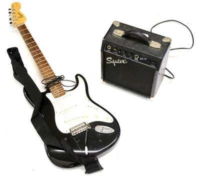 Lot 2094 - A Fender Squier Strat Electric Guitar, made in China, serial number YN693136, with black body, on a