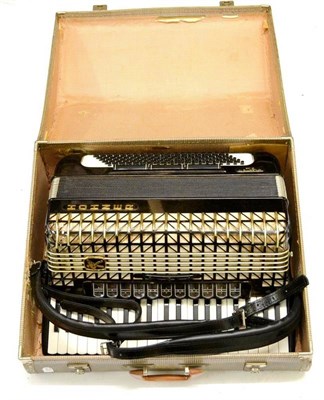 Lot 2113 - A Hohner Atlantic IV De Luxe Piano Accordion, with black and white body, leather strap, cased