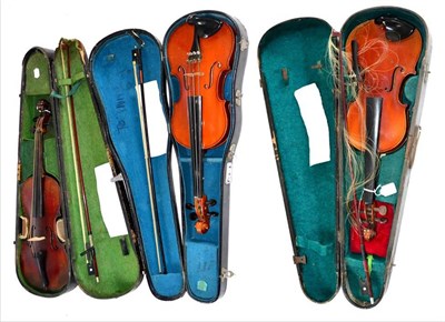 Lot 2028 - Three German Violins, one with Strad label and lions head carved scroll, all with bows and all...