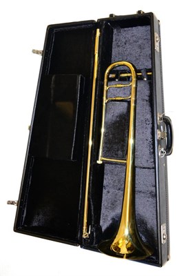 Lot 44 - A Conn 100H Brass Trombone, serial number 5580103, with accessories, in a fitted case