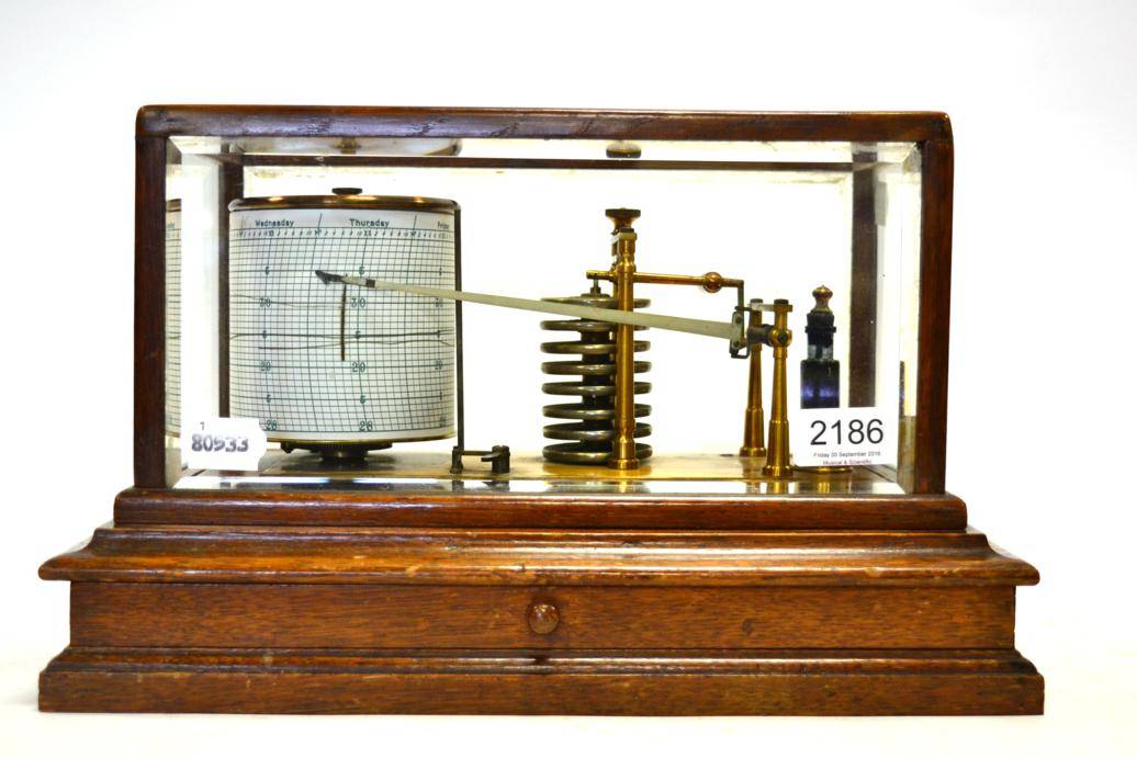 Lot 2186 - Barograph with eight vacuum sections, brass frame and ink bottle, in oak case with drawer and...