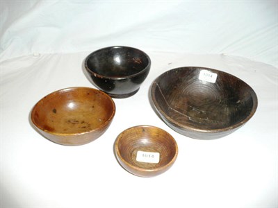 Lot 1014 - Four Various Graduated Turned Beech and Stained Wood Bowls, 18th/19th century, all circular,...