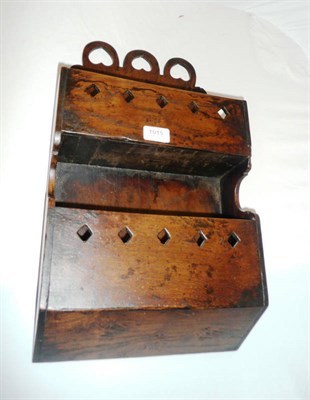 Lot 1015 - An Oak Two-Tier Wall Rack, the backboard with triple inverted heart arched surmount, each open...