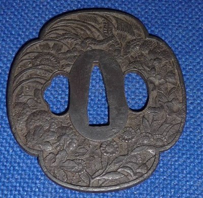 Lot 107 - A Late 17th/Early 18th Century Japanese Iron Tsuba, of Mokko Gata shape, worked with...