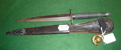 Lot 113 - A Third Pattern Commando Fighting Knife, with machine forged blade, ringed grip and leather...