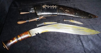 Lot 114 - A Ghurka Rifleman's Standard Issue Kukri,  with brass ringed rosewood grip, leather sheath set with