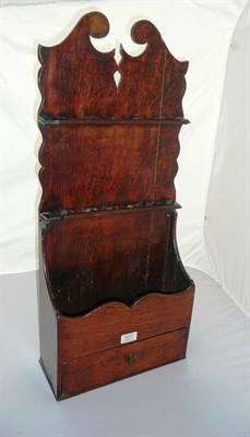 Lot 1017 - A George III Oak Boarded Spoon Rack, the wavy shaped upright with broken arched pediment, the...