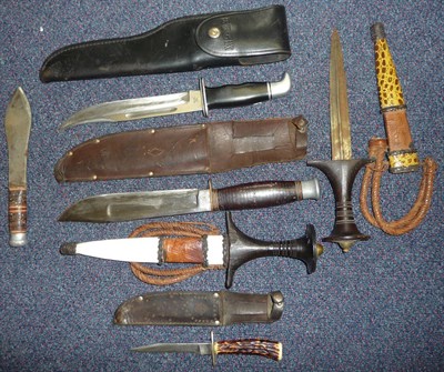 Lot 126 - Two Sudanese Arm Daggers, each with ribbed double edge steel blade, wood grip with disc shape...