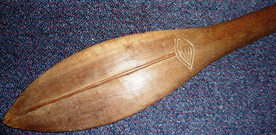 Lot 156 - A Soloman Islands Dark Wood Paddle Club, the pointed flattened lozenge shape blade with raised...