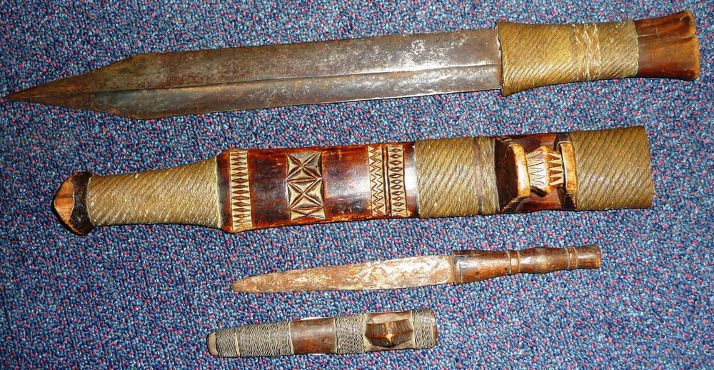 Lot 165 - A Shona Sword, the 35cm double edge with concave fuller to each opposing edge, brass wire bound...