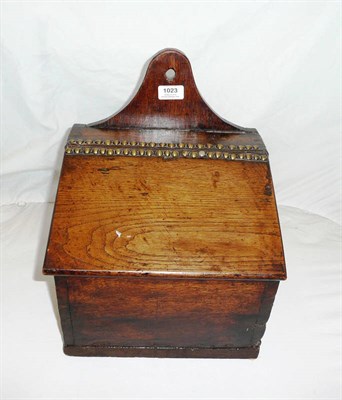 Lot 1023 - An Oak Candle Box, 18th century, arched back panel pierced for suspension, the canted lid with...