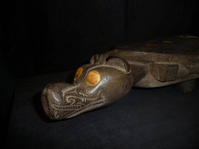 Lot 192 - A Dyak Head Hunter's Dark Hardwood Stool, carved in the form of a stylised fruit bat, the well...