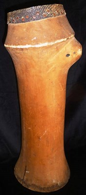 Lot 193 - A North African Wood Anthropomorphic Drum, the tall slightly waisted cylindrical body carved with a