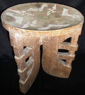 Lot 194 - A Kamba, East Africa Wood Stool, the dished circular seat inlaid with birds and circular panels...