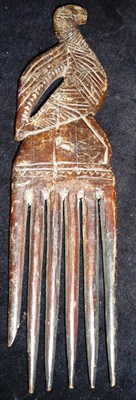 Lot 204 - An African Hardwood Comb, with six long tines, the flat handle pierced and carved as a bird, 26.5cm