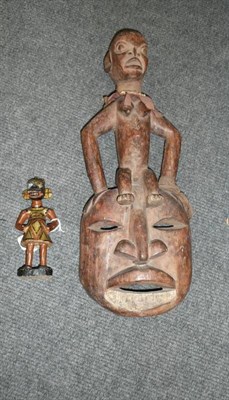 Lot 211 - An African Wood Mask, possibly Grasslands, the headdress carved as a seated woman with pointed...