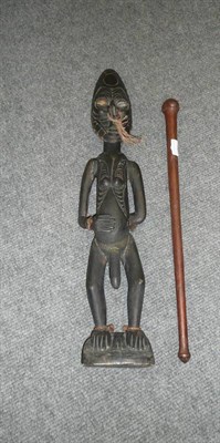 Lot 213 - A Papua New Guinea Ebonised Wood Figure of a Man, standing the large oval face with scarified...