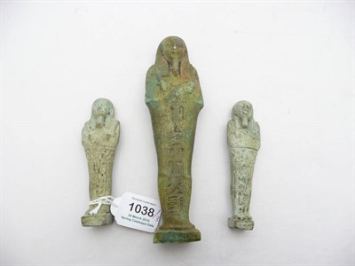 Lot 1038 - An Egyptian Turquoise Glazed Faience Shabti, with impressed hieroglyphics, upon an integral...