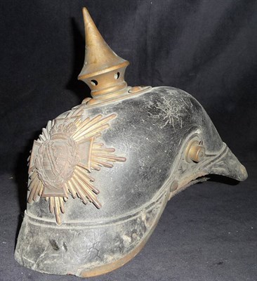 Lot 100 - A Pre First World War Saxon Pickelhaube, of black leather with brass vented spike, back rib...