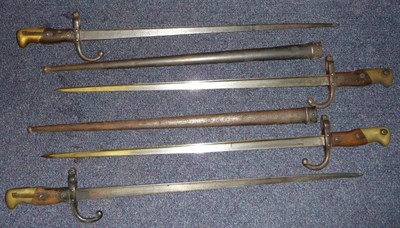 Lot 155 - Four French Model 1874 "Gras" Sword Bayonets, with T section blades, brass mounted wood grips,...