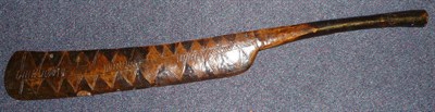 Lot 241 - A New Guinea Wood Sword Club, of dark brown and honey colour, the cleaver type head incised...