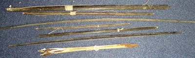 Lot 249 - A Collection of South Sea Islands Hunting Equipment, comprising six black palm wood self bows,...