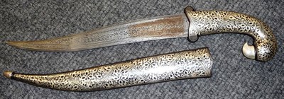 Lot 256 - An Indian Dagger, with curved damascened steel blade, the bird's head hilt and scabbard inlaid with