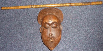 Lot 270 - A Baule, Ivory Coast Wood Mask, with combed crescent shape coifure, oval face with pointed...