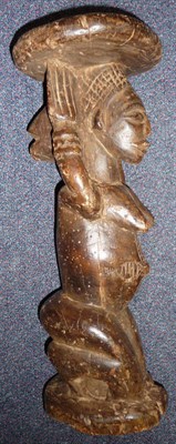 Lot 284 - A Luba, Congo Wood Figure, as a kneeling woman with pendulous breasts, her hands upraised...